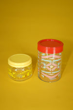 Small vintage glass container in yellow with patterns