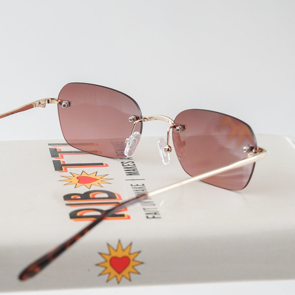 Ribotti Remake Britney unisex sunglasses - minimalist retro Y2K style, rimless gold frame, rose tinted lenses
