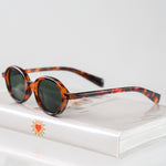 Ribotti Remake Léon Luc unisex sunglasses - timeless minimalist 90s style, round tortoiseshell frame, green tinted lenses 