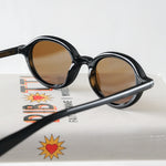 Ribotti Remake Léon Mathilda unisex sunglasses - timeless minimalist 90s style, round black frame, brown tinted lenses 