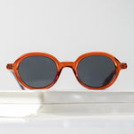 Ribotti Remake Léon Nikita unisex sunglasses - timeless minimalist 90s style, round brown frame, grey tinted lenses 