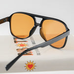 Ribotti Remake Puff Buttercup unisex sunglasses – black oversized aviator frame, orange tinted lenses, slim retro 90s/2000s style 