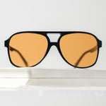 Ribotti Remake Puff Buttercup unisex sunglasses – black oversized aviator frame, orange tinted lenses, slim retro 90s/2000s style 