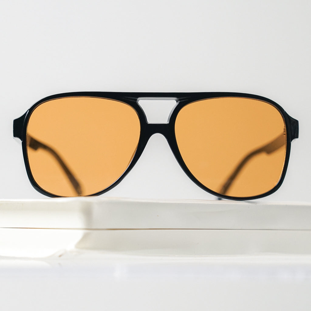 Ribotti Remake Puff Buttercup unisex sunglasses – black oversized aviator frame, orange tinted lenses, slim retro 90s/2000s style 