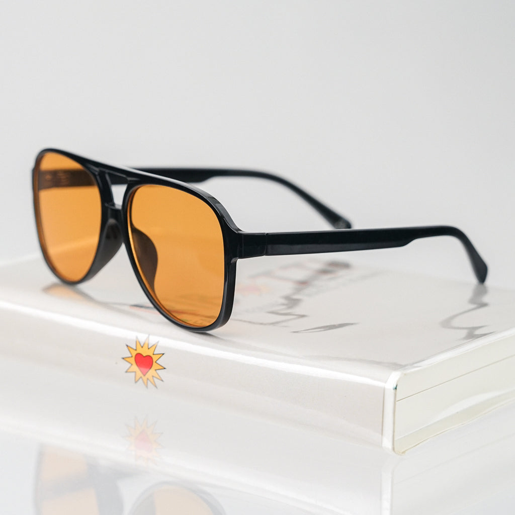 Ribotti Remake Puff Buttercup unisex sunglasses – black oversized aviator frame, orange tinted lenses, slim retro 90s/2000s style 