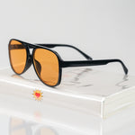 Ribotti Remake Puff Buttercup unisex sunglasses – black oversized aviator frame, orange tinted lenses, slim retro 90s/2000s style 