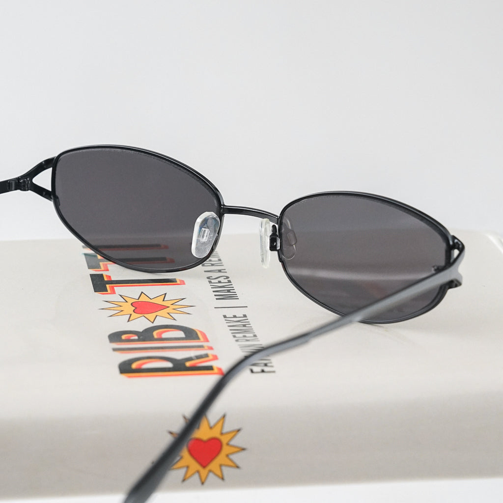 Ribotti Remake Spy Juni unisex sunglasses - black oval frame, black tinted lenses, retro-futuristic minimalist 2000s style 