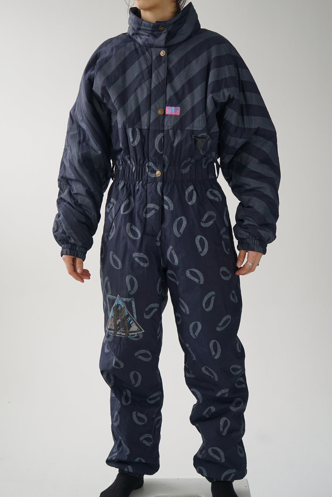 Vintage one piece Skila ski suit, dark blue with patterns snow suit size 40