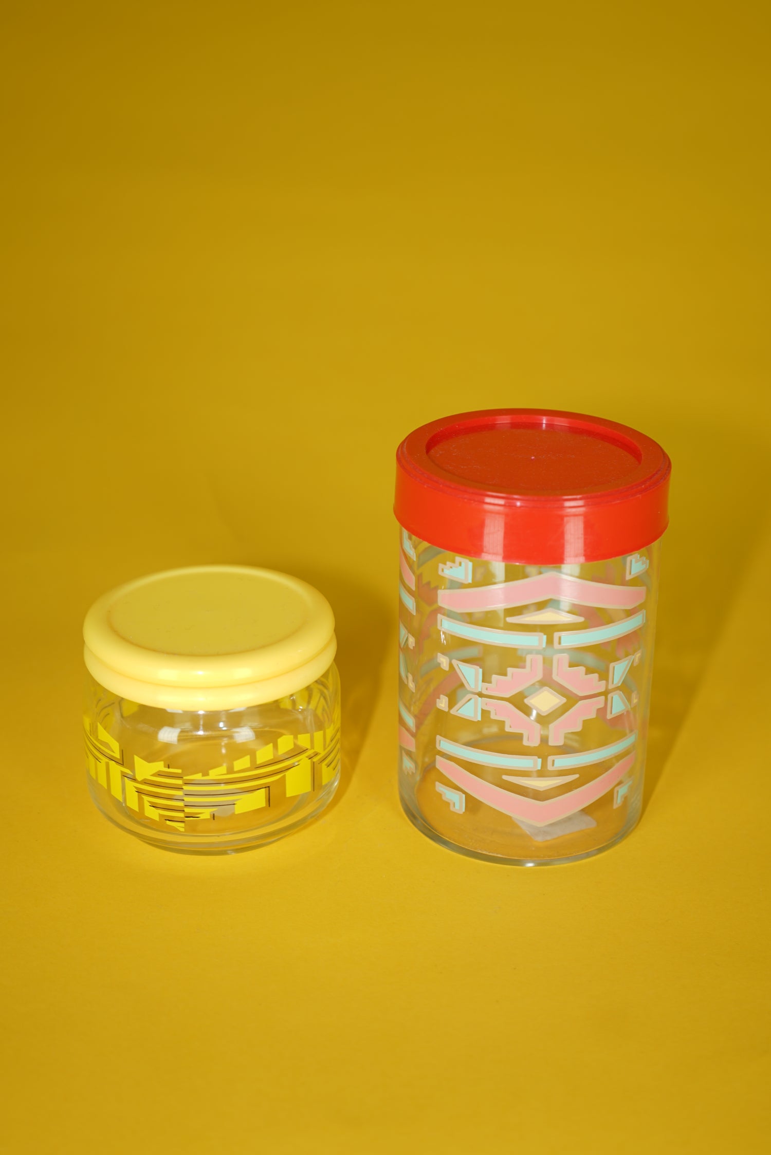 Tall vintage glass container in red with patterns