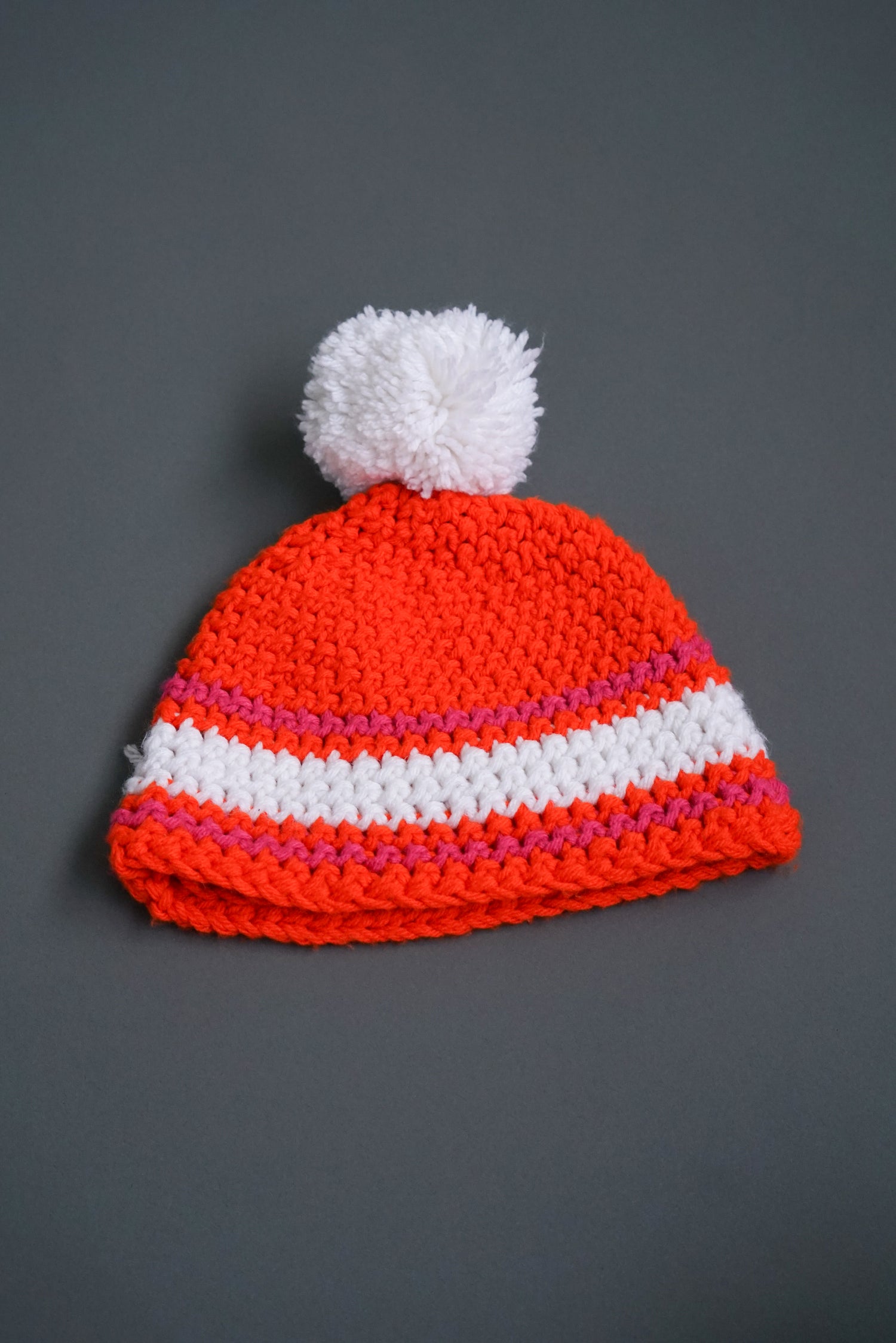 Handmade orange pom-pom beanie